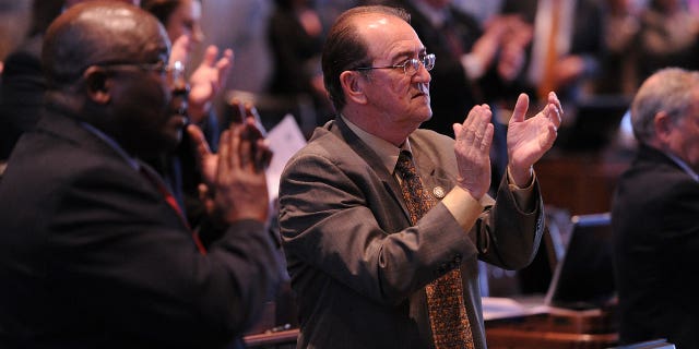 Louisiana state Reps. A.B. Franklin, D-Lake Charles, and Jack Montoucet, D-Crowley, applaud Gov. Bobby Jindal following his speech during the opening of the state Legislature at the state Capitol in Baton Rouge, Louisiana, on March 10, 2014.
