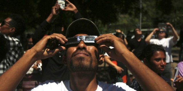A man uses a protective glasses