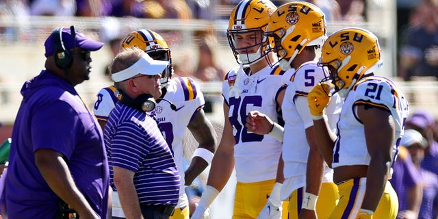 Jayden Daniels of the LSU Tigers talks with head coach Brian Kelly during the Cheez-It Citrus Bowl against the Purdue Boilermakers at Camping World Stadium on Jan. 2, 2023, in Orlando, Florida.