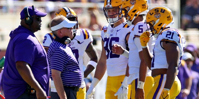 Jayden Daniels of the LSU Tigers talks with head coach Brian Kelly during the Cheez-It Citrus Bowl against the Purdue Boilermakers at Camping World Stadium on Jan. 2, 2023, in Orlando, Florida.