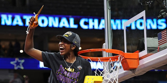 Flau'jae Johnson of the LSU Lady Tigers cuts down a piece of the net after defeating the Iowa Hawkeyes 102-85 in the 2023 NCAA Tournament championship at American Airlines Center April 2, 2023, in Dallas, Texas.