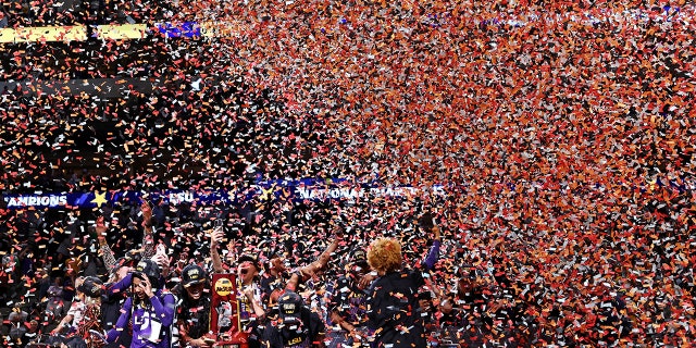 Angel Reese #10 of the LSU Lady Tigers holds the championship trophy as the Tigers celebrate defeating the Iowa Hawkeyes 102-85 during the 2023 NCAA Women's Basketball Tournament championship game at American Airlines Center on April 02, 2023 in Dallas, Texas.