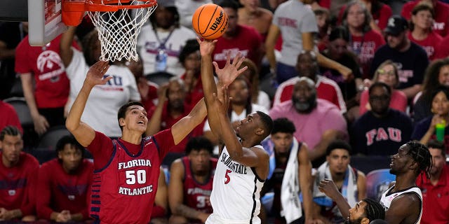 San Diego State guard Lamont Butler (5) shoots over Florida Atlantic center Vladislav Goldin (50) during the first half of a Final Four game in the NCAA Tournament on Saturday, April 1, 2023 In Houston.