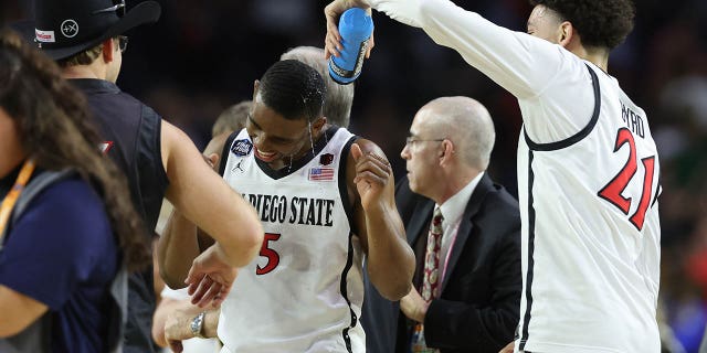 Lamont Butler and Miles Byrd of the San Diego State Aztecs celebrate after defeating the Florida Atlantic Owls on April 01, 2023 in Houston, Texas.