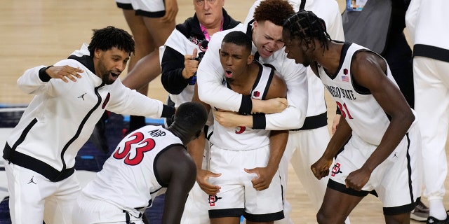 San Diego State guard Lamont Butler celebrates with his teammates after hitting the winning basket against Florida Atlantic on Saturday, April 1, 2023, in Houston.