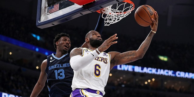 LeBron James #6 of the Los Angeles Lakers goes to the basket against Jaren Jackson Jr. #13 of the Memphis Grizzlies during the first half of Game One of the Western Conference First Round Playoffs at FedExForum on April 16, 2023 in Memphis, Tennessee.