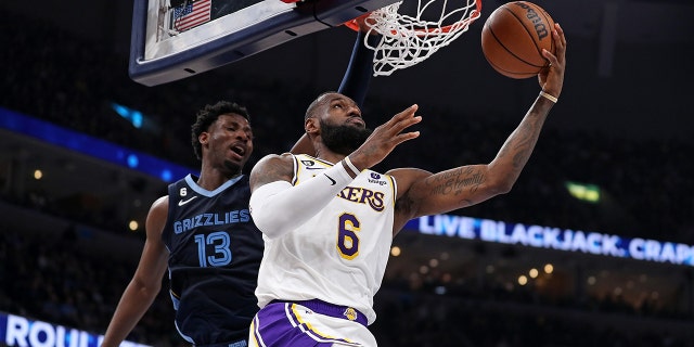 LeBron James #6 of the Los Angeles Lakers goes to the basket against Jaren Jackson Jr. #13 of the Memphis Grizzlies during the first half of Game One of the Western Conference First Round Playoffs at FedExForum on April 16, 2023 in Memphis, Tennessee.