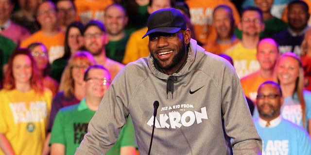 Surrounded by students and community partners, LeBron James talks about the creation of the I Promise School during an LeBron James Family Foundation event on Tuesday, April 11, 2017 at the East End Goodyear Theater in Akron, Ohio.