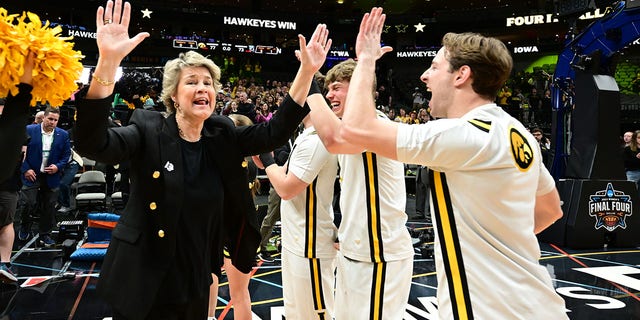 Lisa Bluder, head coach of the Iowa Hawkeyes, celebrates their victory over the South Carolina Gamecocks in the NCAA Tournament Final Four at American Airlines Center on March 31, 2023 in Dallas, Texas.