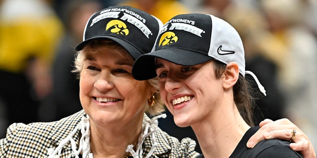 Head coach Lisa Bluder, left, and Caitlin Clark of the Iowa Hawkeyes pose for a photo after defeating the Louisville Cardinals 97-83 in the Elite Eight of the NCAA Tournament at Climate Pledge Arena in Seattle on March 26, 2023.