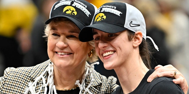 Head coach Lisa Bluder, left, and Caitlin Clark of the Iowa Hawkeyes pose for a photo after defeating the Louisville Cardinals 97-83 in the Elite Eight of the NCAA Tournament at Climate Pledge Arena in Seattle on March 26, 2023.