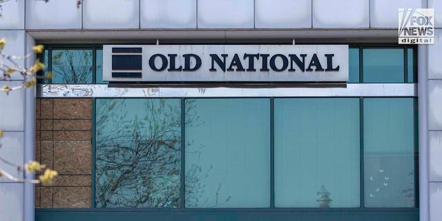 What appears to be bullet holes marked with tape remain visible in the windows of the Old National Bank in downtown Louisville