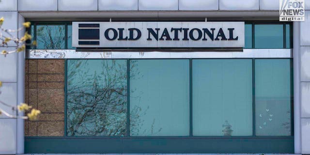 What appears to be bullet holes marked with tape remain visible in the windows of the Old National Bank in downtown Louisville