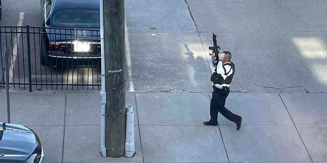 This photo provided by Reid Cornell shows police presence near the scene of a shooting in Louisville, Monday, April 10, 2023.