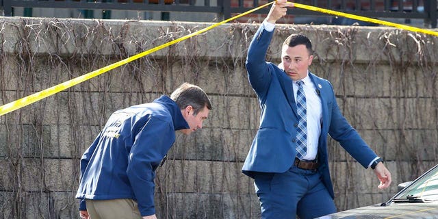 Kentucky Gov. Andy Beshear, left, arrives at the scene of a shooting in downtown Louisville on Monday, April 10, 2023. 