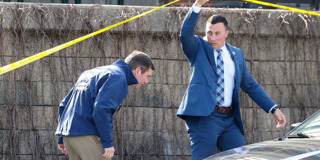 Kentucky Gov. Andy Beshear, left, arrives at the scene of a shooting in downtown Louisville on Monday, April 10, 2023.