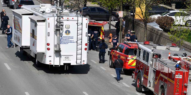 The Louisville Metro Police Department and Louisville Fire Department gather a block from the Old National Bank building in Louisville, Kentucky, on April 10, 2023.