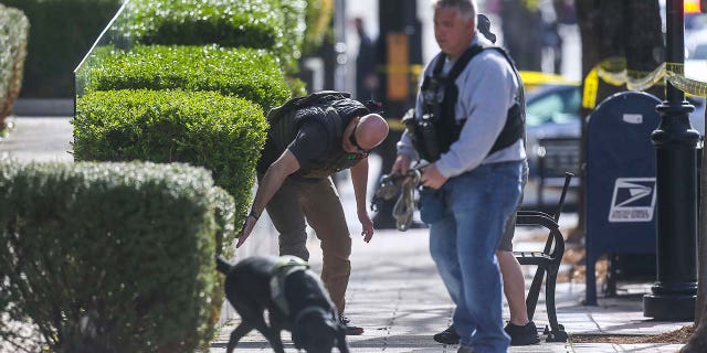 LMPD officers search for evidence after five people were killed and six injured, including a LMPD officer, in a deadly Monday morning shooting at Old National Bank in downtown Louisville. April 9, 2023