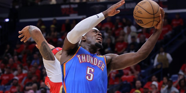 Luguentz Dort #5 of the Oklahoma City Thunder shoots against Brandon Ingram #14 of the New Orleans Pelicans during the first half at the Smoothie King Center on April 12, 2023, in New Orleans, Louisiana.