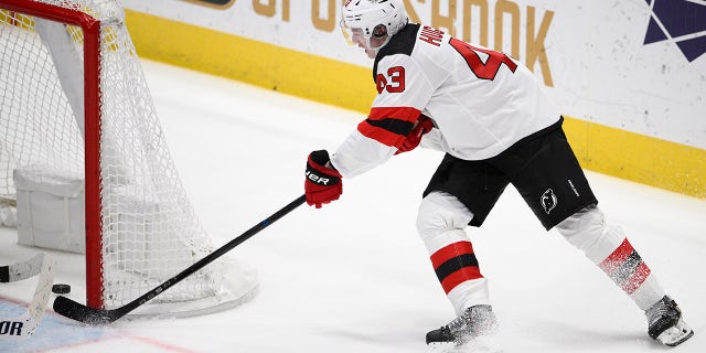 New Jersey Devils defenseman Luke Hughes scores the game-winning goal in overtime against the Washington Capitals, Thursday, April 13, 2023.