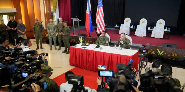 U.S. Marine Corps Major General Eric Austin, right, U.S. Exercise Director Representative, right, with Philippine Army Major General Marvin Licudin, Philippine Exercise Director, answers a question from a reporter after the opening ceremonies of a joint military exercise flag called "Balikatan," a Tagalog word for "shoulder-to-shoulder," at Camp Aguinaldo military headquarters on April 11, 2023, in Quezon City, Philippines.