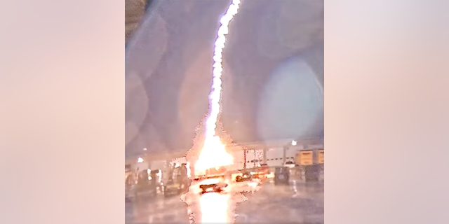 A lightning bolt flashes and strikes a Greene County Highway Department truck.