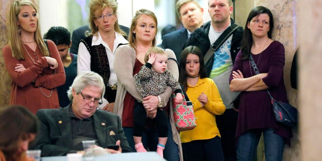 Parents with their children and medical professionals listen to testimony from proponents for allowing exemption from the vaccination requirement for school attendance based on religious beliefs during a meeting of House Judiciary B Committee, Jan. 24, 2018, at the Capitol in Jackson, Mississippi.