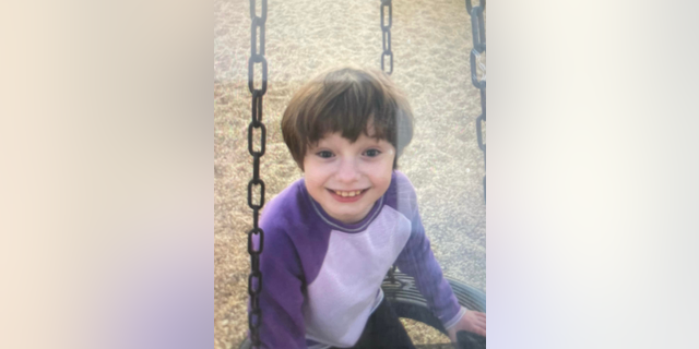 Maddelynn Wallace smiling on swing set