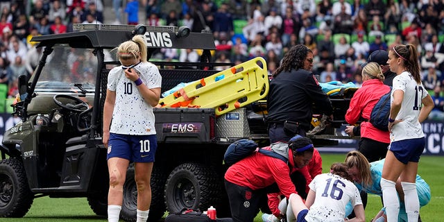 United States midfielder Lindsey Horan (10) and other players stand by as teammate Mallory Swanson receives medical attention after an injury in the first half of an international friendly soccer match against Ireland in Austin, Texas, Saturday, April 8, 2023. 