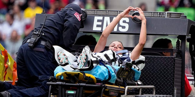 United States forward Mallory Swanson signals to fans as she is taken off the field after an injury during the first half of an international friendly soccer match against Ireland in Austin, Texas, Saturday, April 8, 2023. 