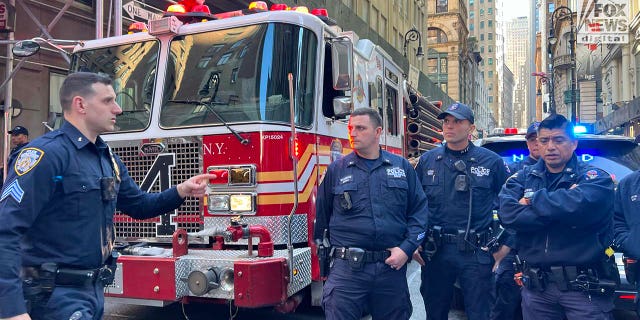 NYPD officers inspect the site of a garage collapse at 57 Ann Street in New York City, Tuesday, April 18, 2023.