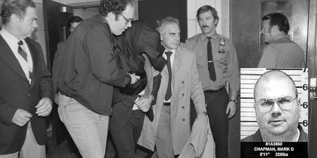 Mark David Chapman is escorted out of a police station after fatally shooting John Lennon on Dec. 9, 1980.