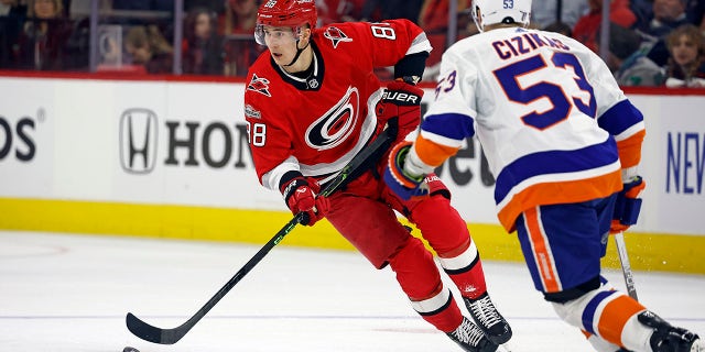 Carolina Hurricanes' Martin Necas (88) skates with the puck around New York Islanders' Casey Cizikas (53) during the second period of Game 1 of an NHL hockey Stanley Cup first-round playoff series in Raleigh, N.C., Monday, April 17, 2023.