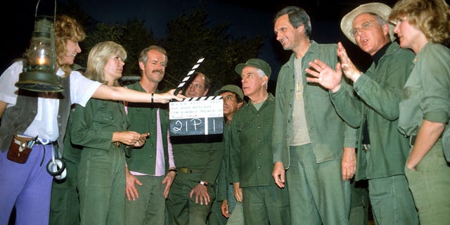 Judy Farrell and the cast of "M*A*S*H" film the final episode in 1983.