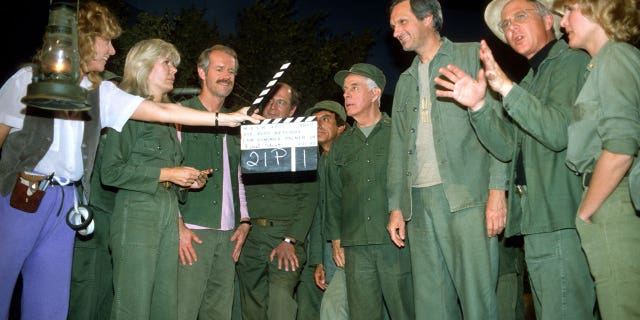 Judy Farrell and the cast of "M*A*S*H" film the final episode in 1983.