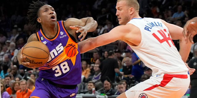 Suns guard Saben Lee drives around LA Clippers center Mason Plumlee, Sunday, April 9, 2023, in Phoenix.