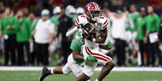 Michael Jefferson #8 of the Louisiana-Lafayette Ragin Cajuns catches a pass over Micah Abraham #6 of the Marshall Thundering Herd during the R+L Carriers New Orleans Bowl at Caesars Superdome on December 18, 2021 in New Orleans, Louisiana.