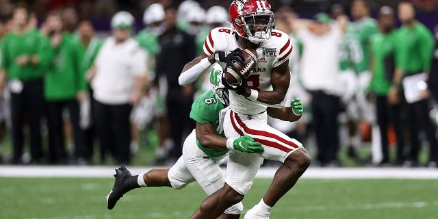 Michael Jefferson #8 of the Louisiana-Lafayette Ragin Cajuns catches a pass over Micah Abraham #6 of the Marshall Thundering Herd during the R+L Carriers New Orleans Bowl at Caesars Superdome on December 18, 2021 in New Orleans, Louisiana.