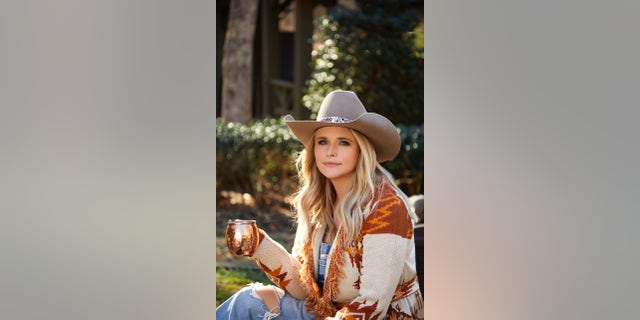 Miranda Lambert in a cowboy hat with a moscow mule mug