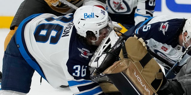 Winnipeg Jets center Morgan Barron, #36, gets his face cut on the skate of Vegas Golden Knights goaltender Laurent Brossoit, #39, during the first period of Game 1 of an NHL hockey Stanley Cup first-round playoff series Tuesday, April 18, 2023, in Las Vegas.
