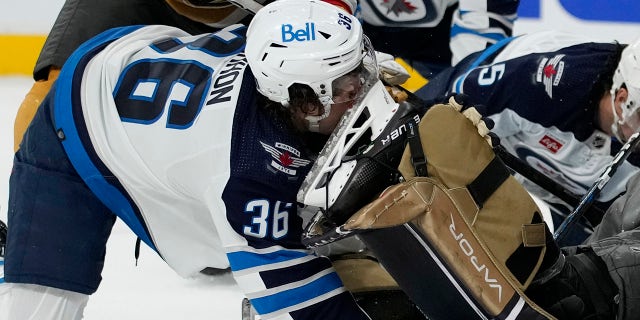 Winnipeg Jets center Morgan Barron, #36, gets his face cut on the skate of Vegas Golden Knights goaltender Laurent Brossoit, #39, during the first period of Game 1 of an NHL hockey Stanley Cup first-round playoff series Tuesday, April 18, 2023, in Las Vegas.