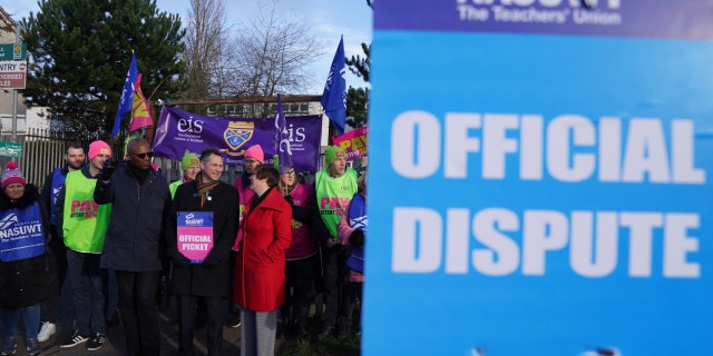 NASUWT leaders and teachers picket outside St. Andrew's RC Secondary School in Glasgow, Scotland, as they take strike action in a dispute over pay.