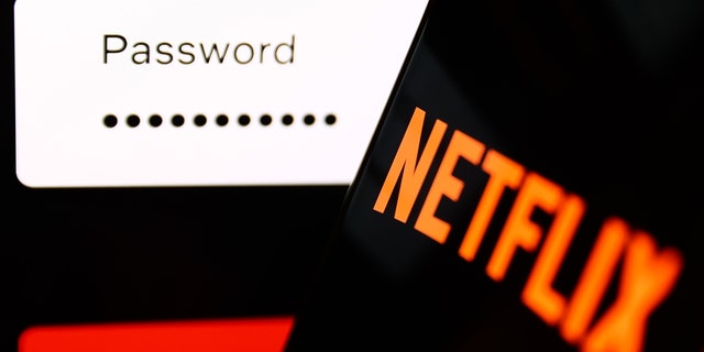 The Netflix sign-in page displayed on a laptop screen and the Netflix logo on a phone screen