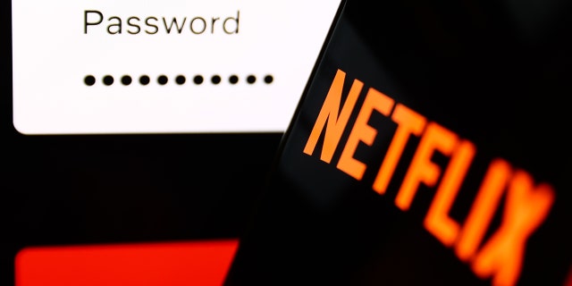 The Netflix sign-in page displayed on a laptop screen and the Netflix logo on a phone screen