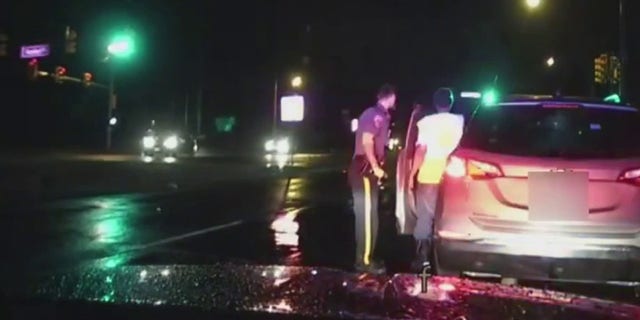 police officer helping driver