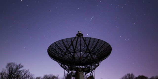 A meteor streaks across the night sky at the InfoAge Space Exploration Center in Wall Township of New Jersey, as the Lyrids meteor shower reached its maximum in the early morning of April 22, 2022. 