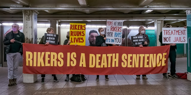Participants seen holding a banner at the protest. Members of the activist group Rise and Resist gathered at the weekly Close Rikers Vigil event held at the Shuttle concourse in the Times Square Subway Station, April 3, 2023.