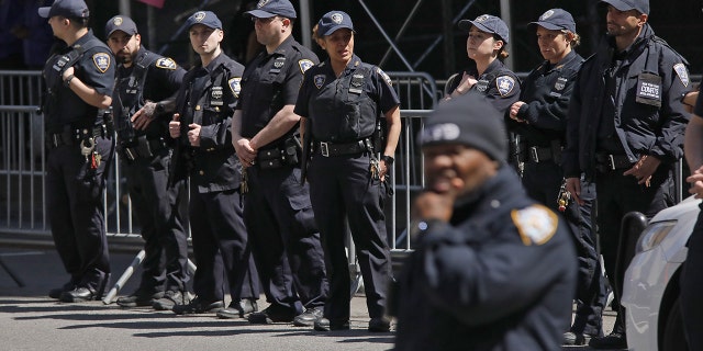 NYPD officers gather outside the Manhattan Criminal Courthouse on April 04, 2023 in New York City. Former President Donald Trump will be arraigned today following his indictment by a grand jury on charges related to money he paid in 2016 to adult film actress Stormy Daniels.