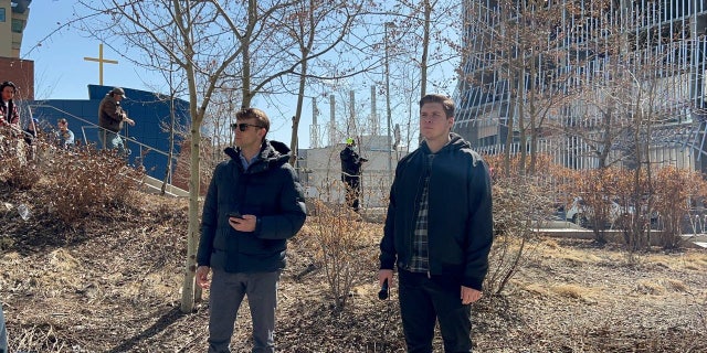 Nathaniel Pawlowski and friend Deklan Friesen address the crowd outside the Calgary Public Library.