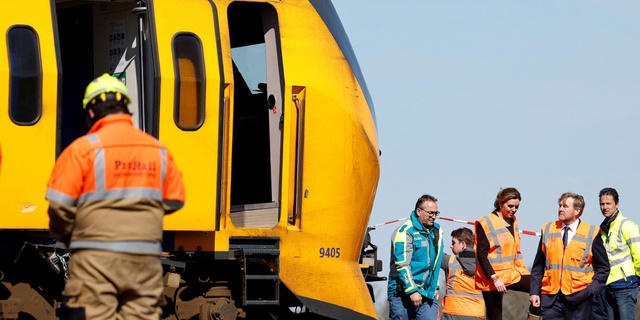 King Willem-Alexander of the Netherlands, bottom right, is seen inspecting the crash site.